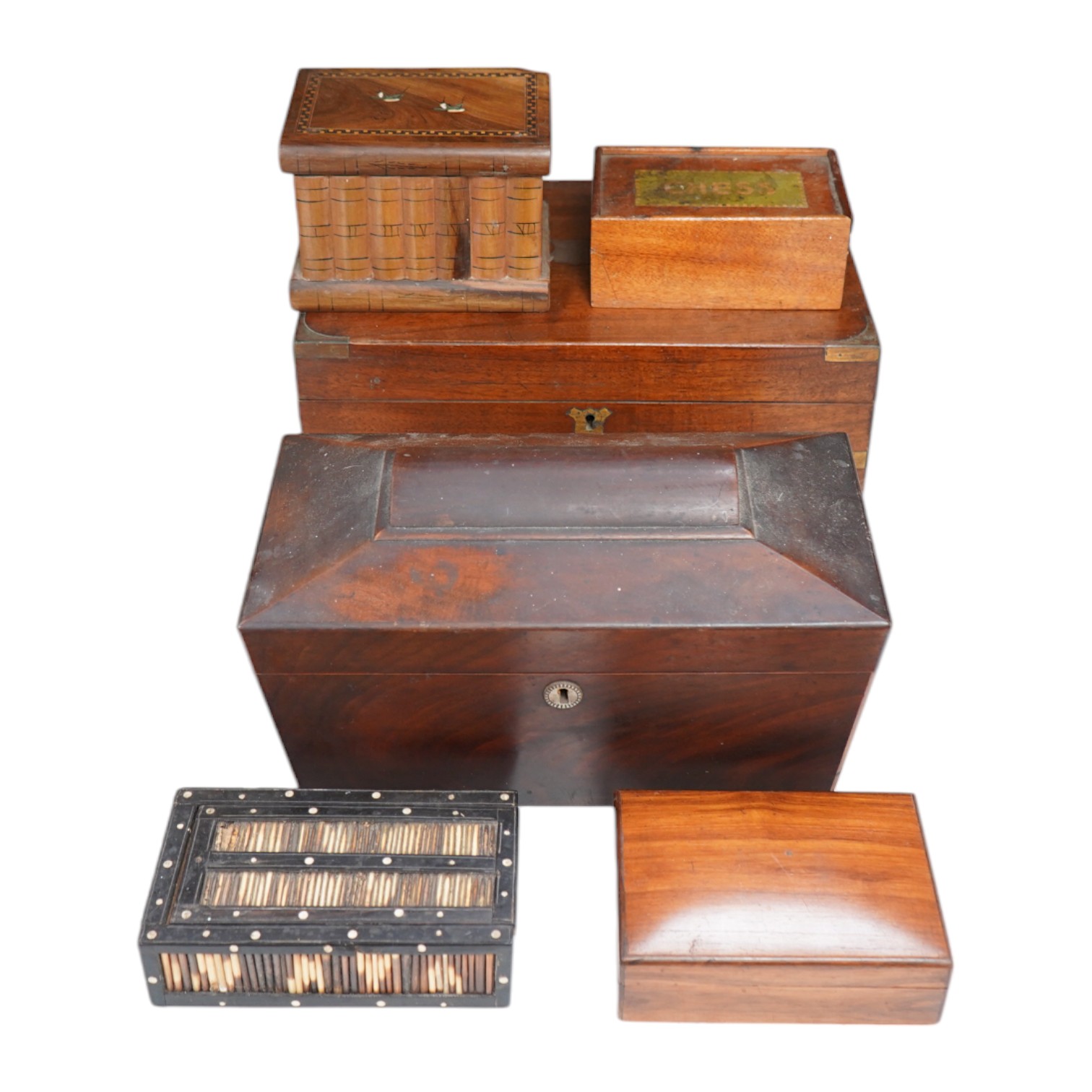 Six 19th century and later boxes to include a writing box, tea caddy, quill box and a jewellery box in the form of books with mirrored interior, largest 35cm wide. Condition - varies